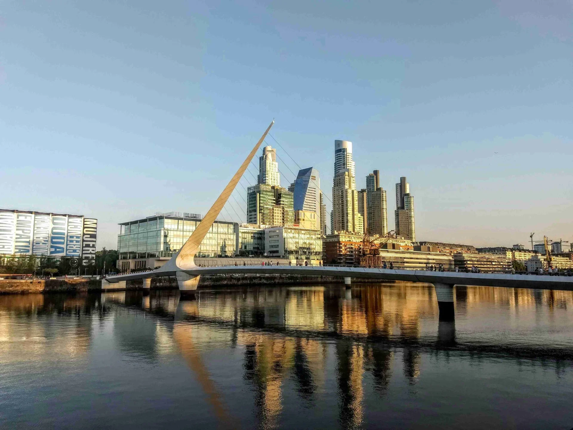 Lakeside Walkway with Cityscape and Mountains