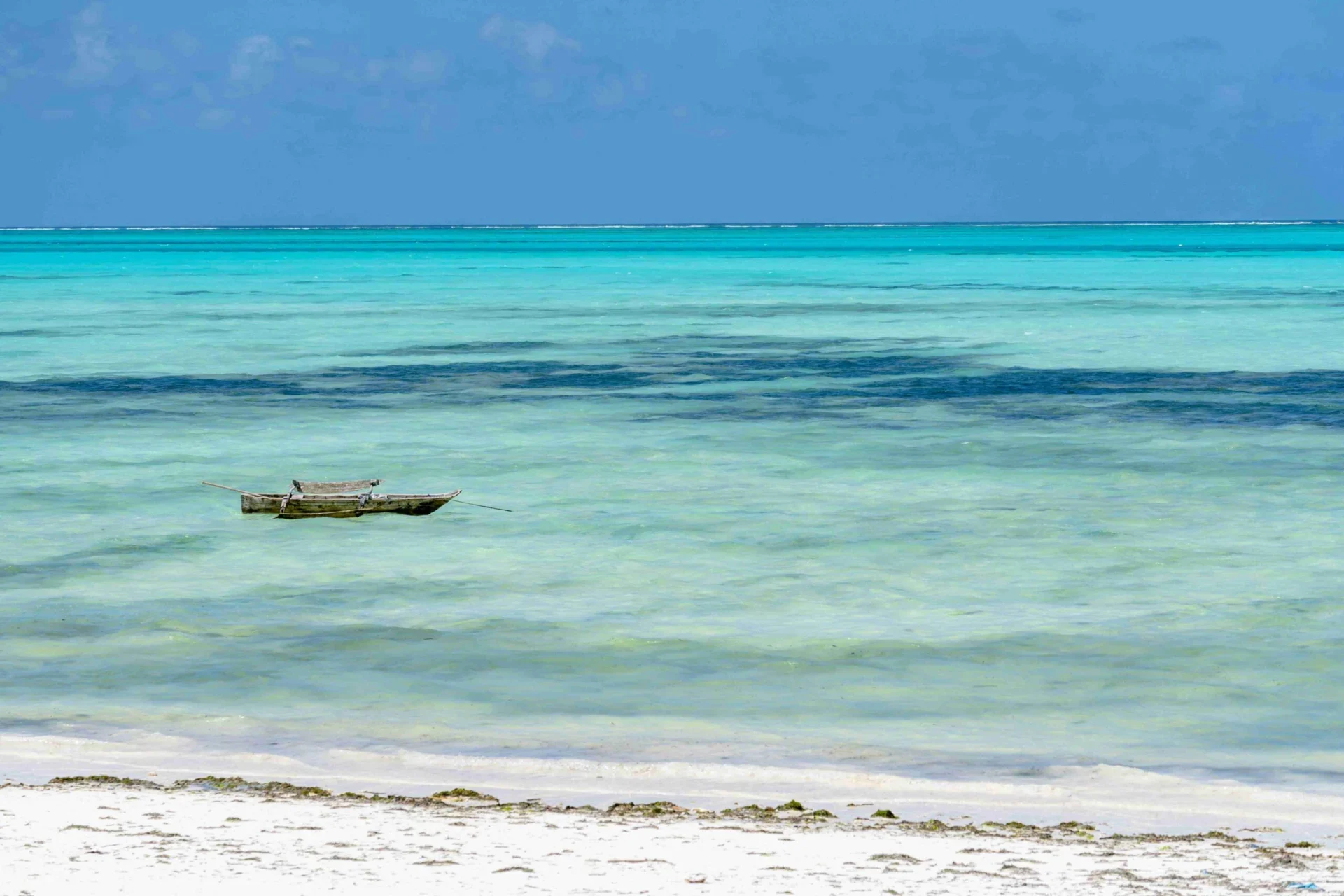 an-aerial-view-of-a-beach-with-a-boat-in-the-water