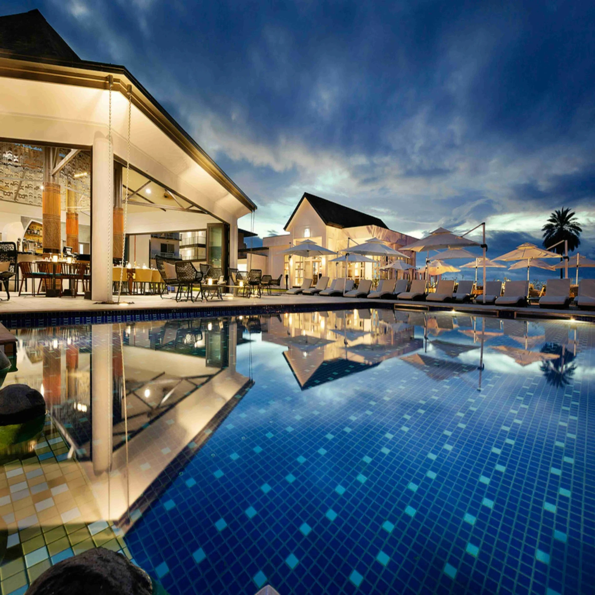 Tranquil Poolside Setup with Loungers and Table