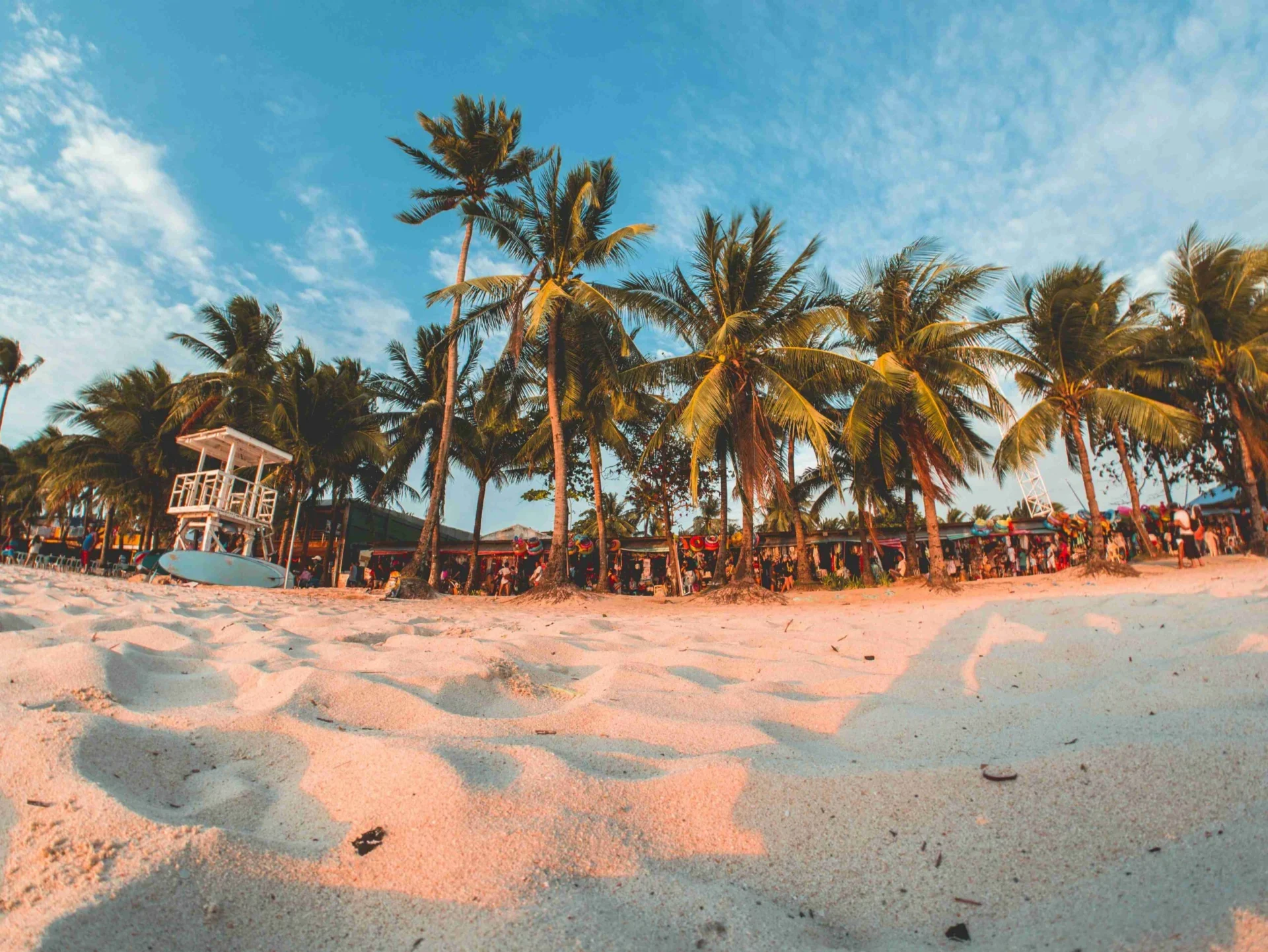 Tropical Beach with Tourists and Traditional Filipino Boats