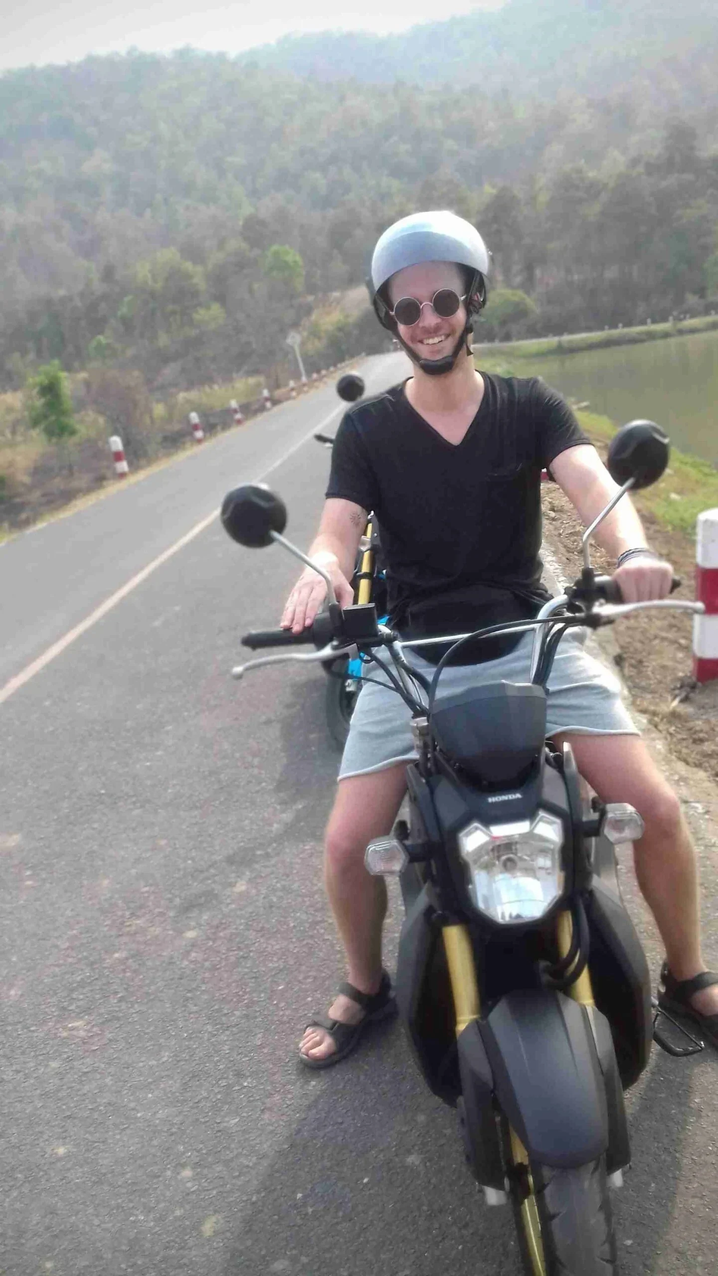 Mark on a scooter overlooking a body of water.